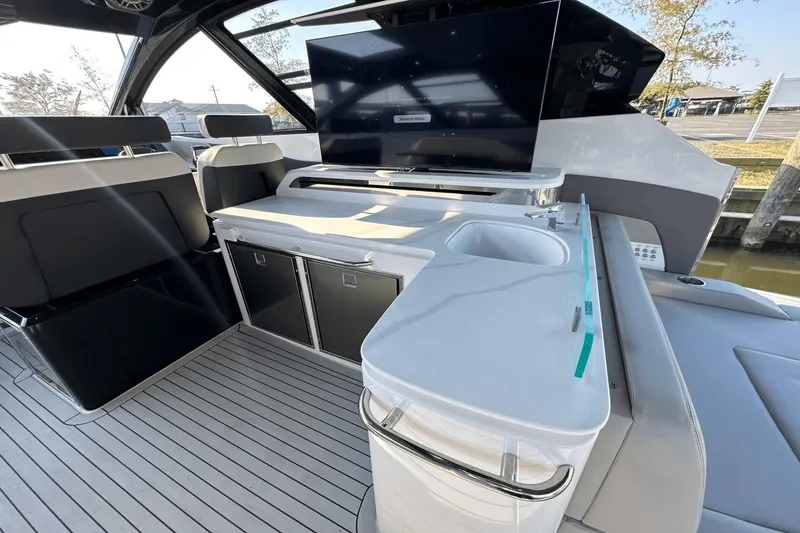 Slide: The Image of Luxurious 2024 Cruisers Yachts 50 GLS interior with sleek seating and modern amenities. - 30