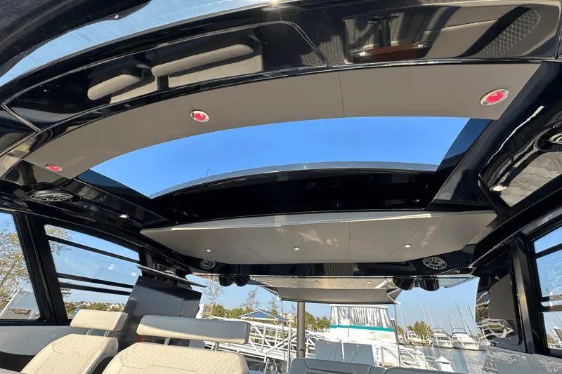 Slide: The Image of Interior view of 2024 Cruisers Yachts 50 GLS with open sunroof and luxurious seating. - 31