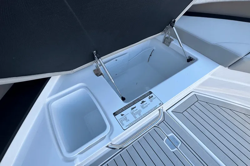 Slide: The Image of Open storage compartment on 2024 Cruisers Yachts 50 GLS with detailed specifications label. - 32