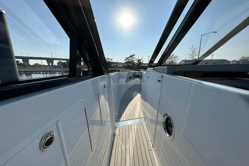Slide: The Image of 2024 Cruisers Yachts 50 GLS deck with sleek design under bright sun. - 36
