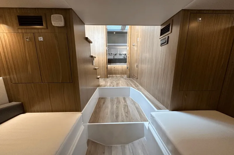 Slide: The Image of Interior of 2024 Cruisers Yachts 50 GLS, featuring modern wood paneling and seating. - 42