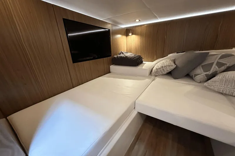 Slide: The Image of Luxurious cabin interior of 2024 Cruisers Yachts 50 GLS with modern decor and cozy bedding. - 43