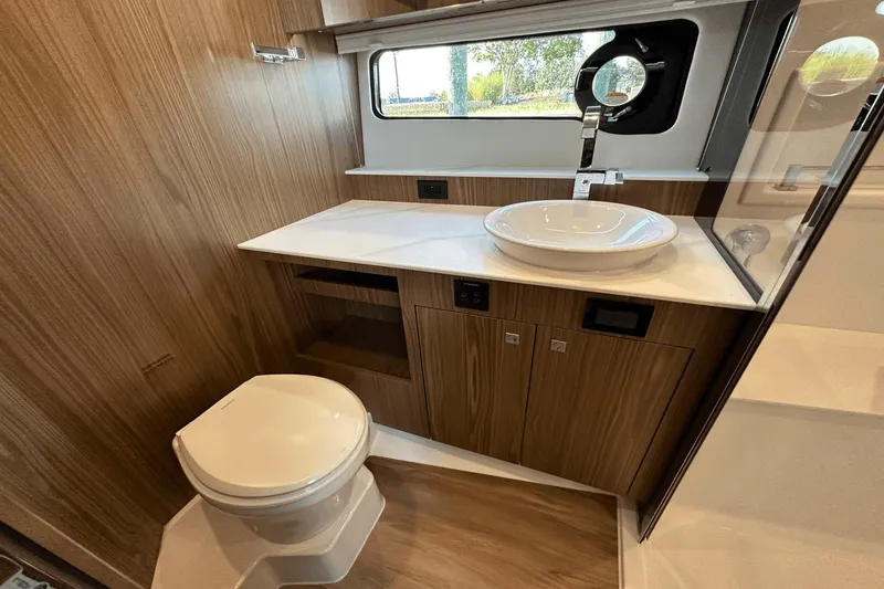 Slide: The Image of Luxurious 2024 Cruisers Yachts 50 GLS bathroom with modern fixtures and wood accents. - 46