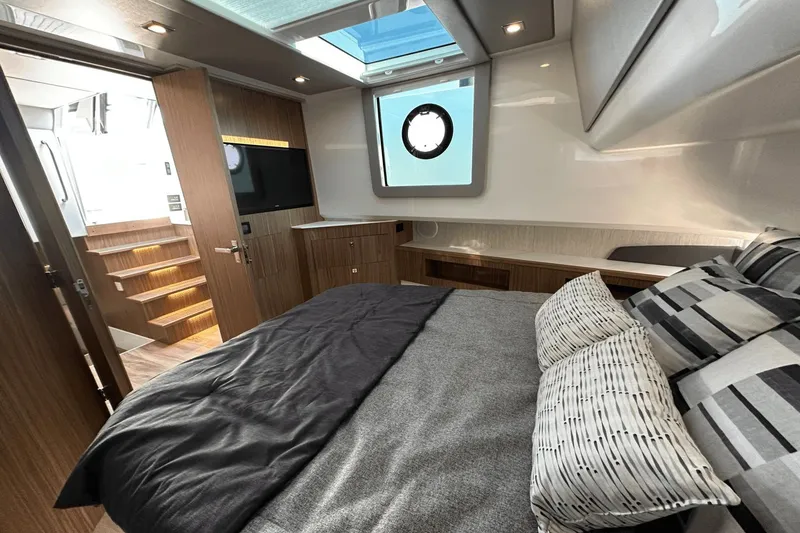 Slide: The Image of Luxurious 2024 Cruisers Yachts 50 GLS cabin interior with modern design and skylight. - 48