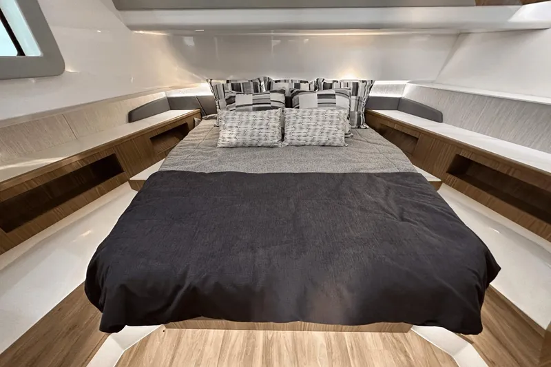 Slide: The Image of Luxurious cabin interior of 2024 Cruisers Yachts 50 GLS with elegant bedding and wood accents. - 49