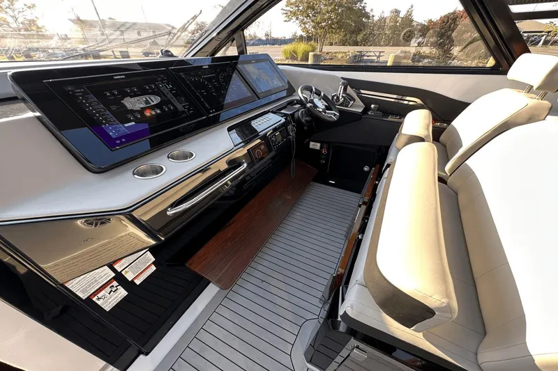 Slide: The Image of 2024 Cruisers Yachts 50 GLS helm with modern controls and luxurious seating. - 50