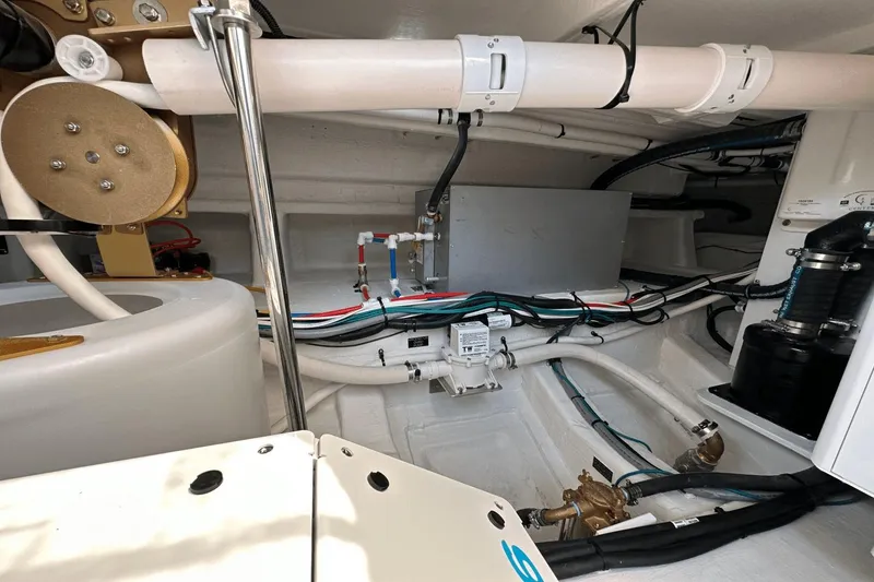 Slide: The Image of Engine room of 2024 Cruisers Yachts 50 GLS, showcasing mechanical components and wiring. - 58