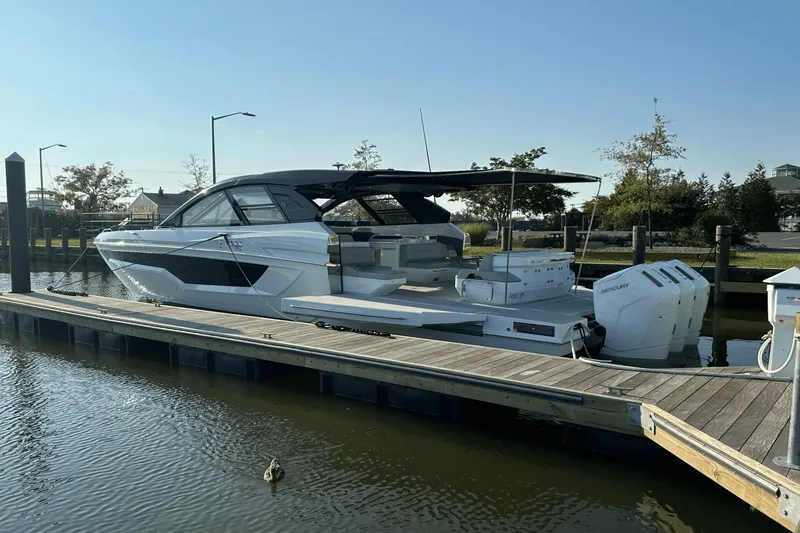 Slide: The Image of 2024 Cruisers Yachts 50 GLS docked, showcasing sleek design and powerful engines. - 8