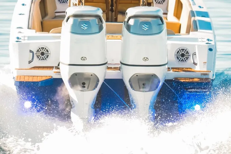 Slide: The Image of Dynamic D-305V 2023 boat with dual outboard motors cruising on water. - 11