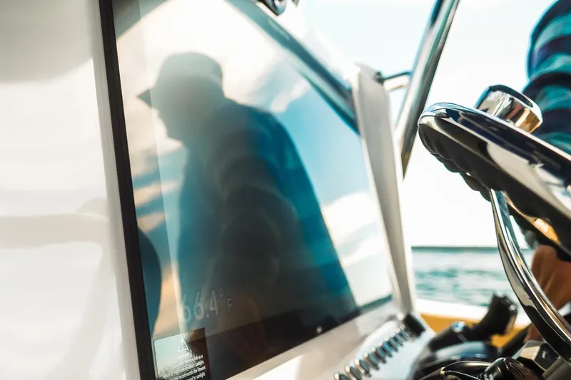 Slide: The Image of Close-up of Dynamic D-305V boat dashboard with steering wheel, reflecting a person. - 13