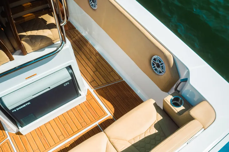 Slide: The Image of Luxurious 2023 Dynamic D-305V boat interior with teak flooring and cushioned seating. - 22