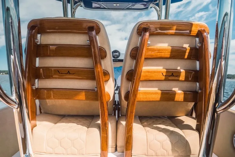 Slide: The Image of Luxurious seating on 2023 Dynamic D-305V boat with wooden accents and beige upholstery. - 26