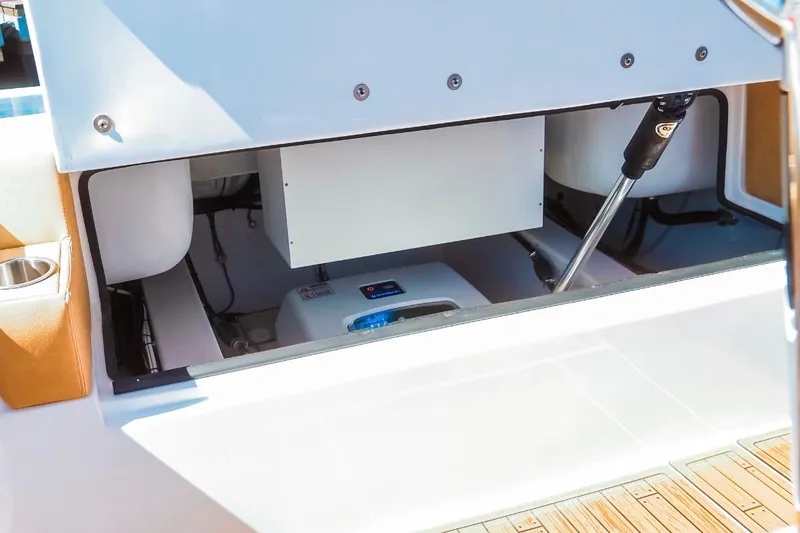 Slide: The Image of Open storage compartment in 2023 Dynamic D-305V boat, showcasing interior components. - 28
