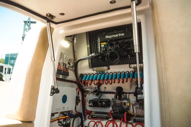 Slide: The Image of Electrical panel inside Dynamic D-305V boat, showcasing advanced wiring and Raymarine equipment, 2023 model. - 29