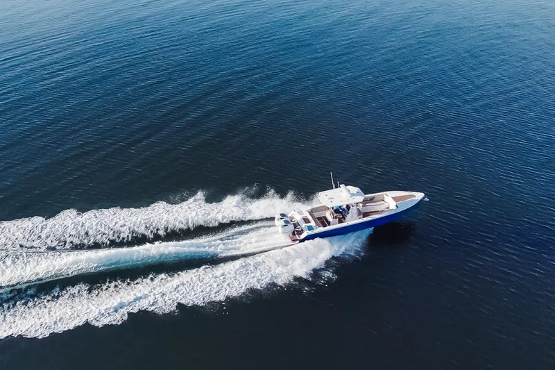 Slide: The Image of Aerial view of Dynamic D-305V boat cruising on open water, 2023 model. - 4