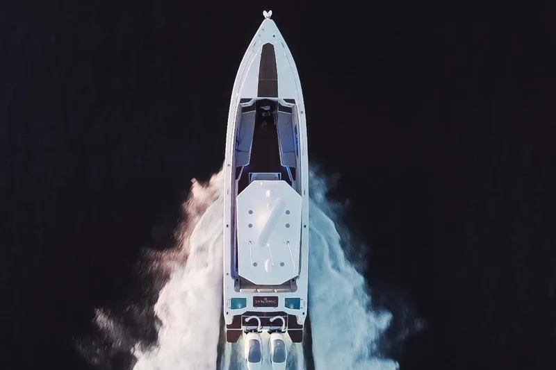 Slide: The Image of Aerial view of 2023 Dynamic D-305V boat cruising on dark water. - 5