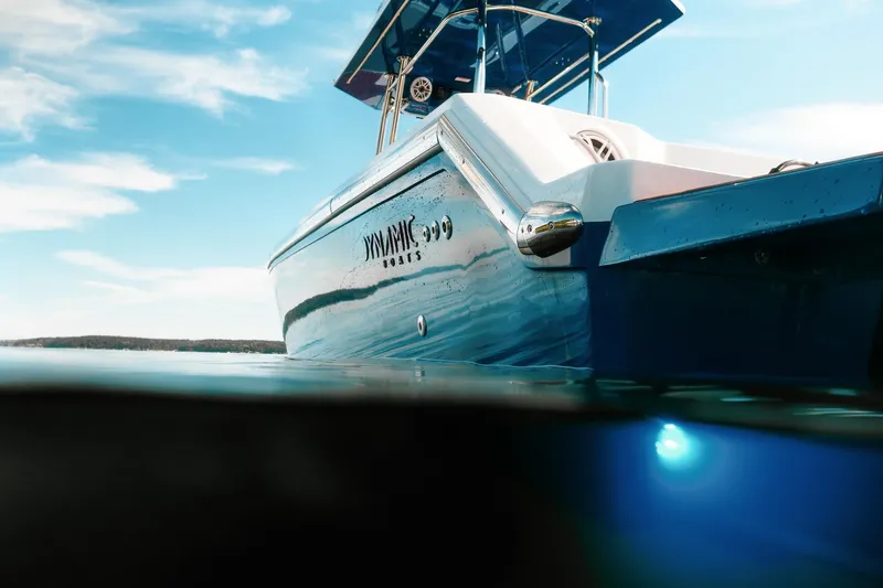 Slide: The Image of Dynamic D-305V boat on water, showcasing sleek design under clear blue sky. - 8
