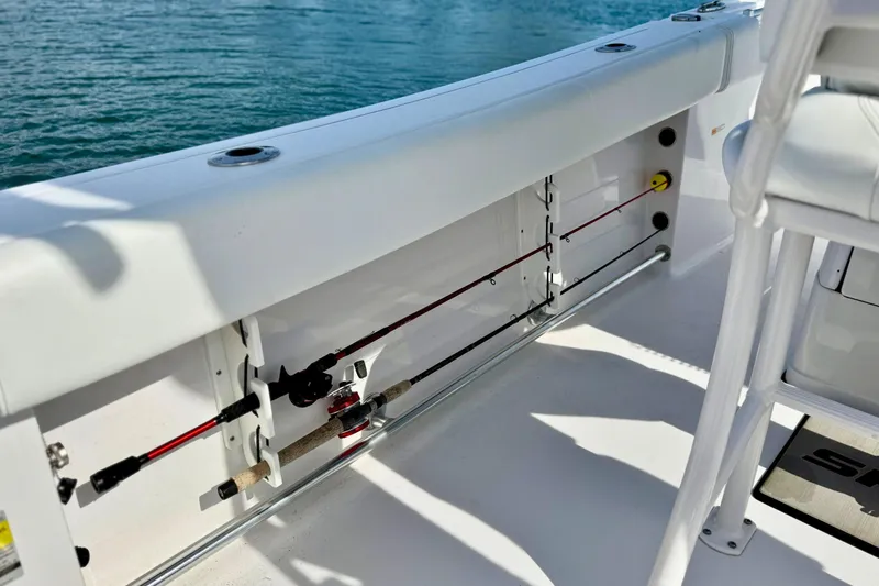 Slide: The Image of 2024 Sportsman Heritage 231 Center Console boat interior detail by the water. - 11