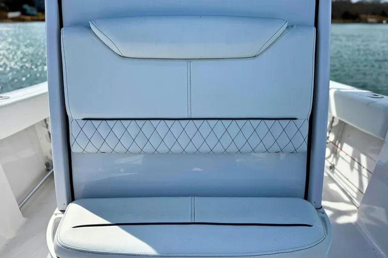 Slide: The Image of 2024 Sportsman Heritage 231 Center Console boat with white cushioned seating. - 21