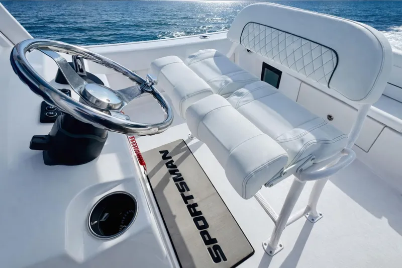 Slide: The Image of 2024 Sportsman Heritage 231 Center Console boat interior with steering wheel and seating. - 27