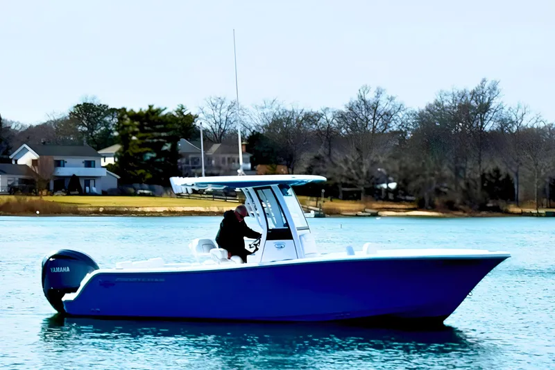 Slide: The Image of 2024 Sportsman Heritage 231 Center Console boat on clear blue water. - 3