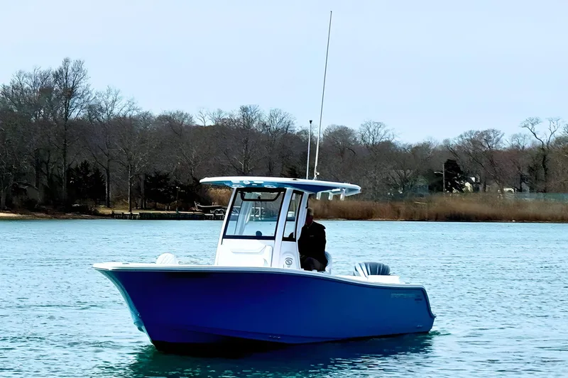Slide: The Image of 2024 Sportsman Heritage 231 Center Console boat on calm blue water. - 4