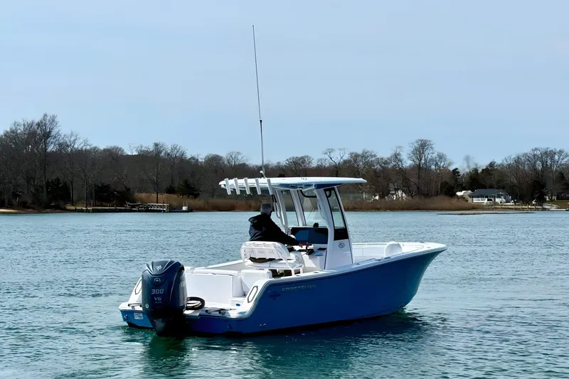 Slide: The Image of 2024 Sportsman Heritage 231 Center Console boat on clear blue water. - 5