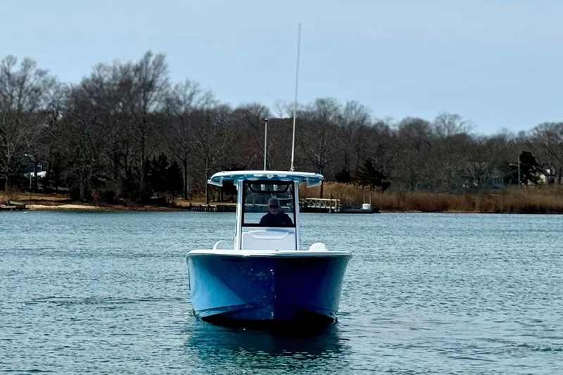Slide: The Image of 2024 Sportsman Heritage 231 Center Console boat on clear blue water. - 6