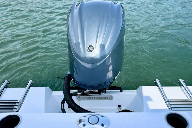Slide: The Image of 2024 Sportsman Heritage 231 Center Console boat on clear blue water. - 8