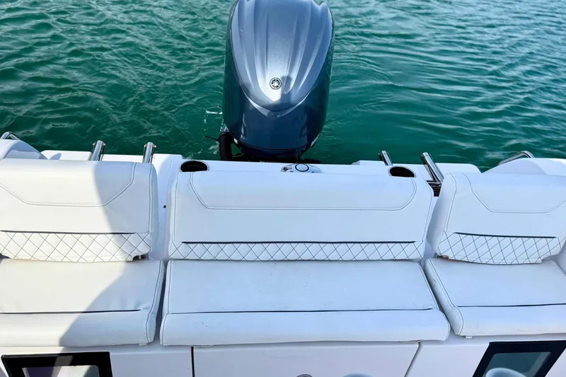 Slide: The Image of 2024 Sportsman Heritage 231 Center Console boat engine on water. - 9