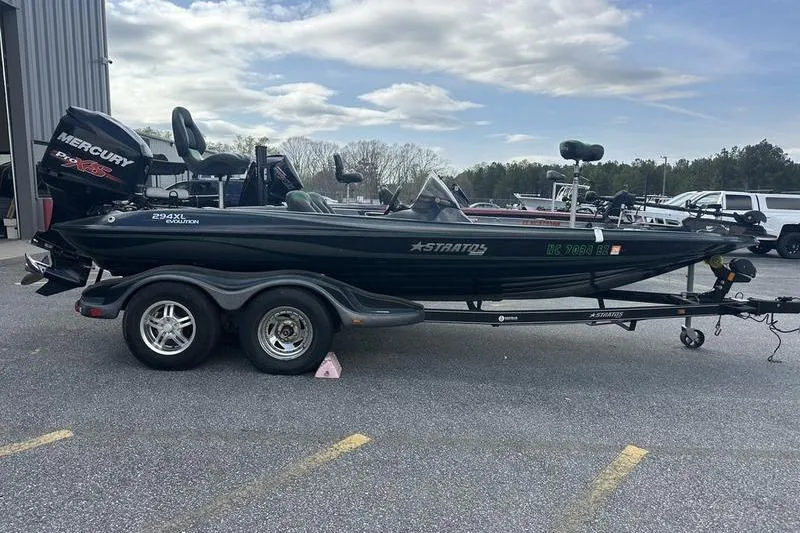 The Image of 2016 Stratos 294 XL Evolution boat on trailer, parked outdoors. - 1
