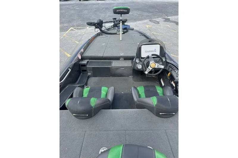 Slide: The Image of 2016 Stratos 294 XL Evolution boat interior with Garmin navigation and green-accented seats. - 5