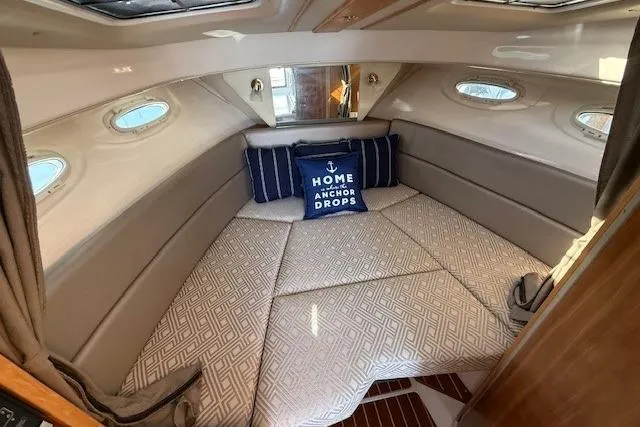 Slide: The Image of 2019 Cutwater 28 cabin interior with cozy bedding and decorative pillow. - 16