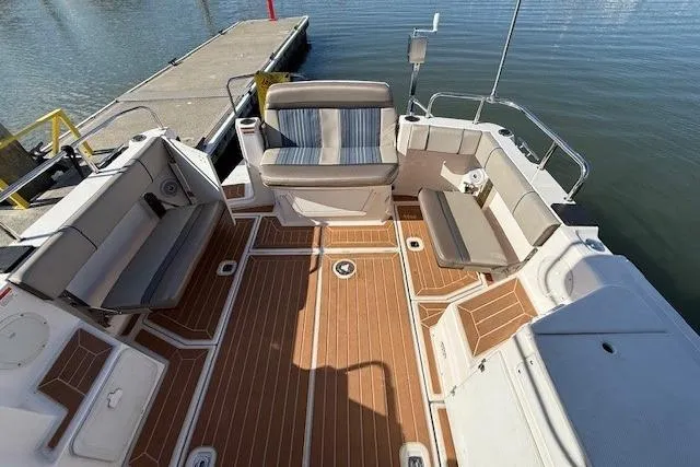 Slide: The Image of 2019 Cutwater 28 boat interior with spacious seating and wood-patterned flooring. - 19
