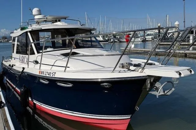 Slide: The Image of 2019 Cutwater 28 boat docked at marina with clear blue sky. - 3