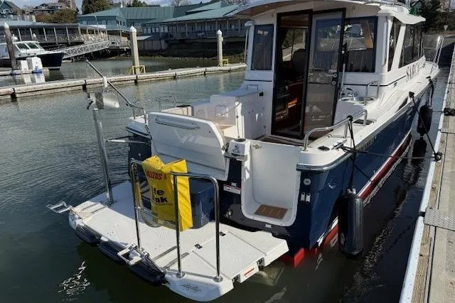 Slide: The Image of 2019 Cutwater 28 boat docked at marina with swim platform and safety equipment. - 5