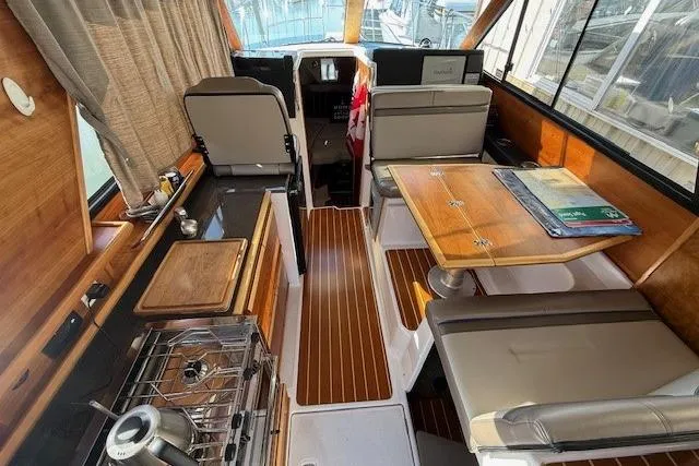 Slide: The Image of Interior of a 2019 Cutwater 28 boat with wood accents and seating area. - 8