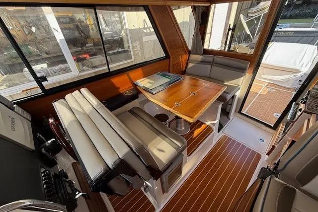 Slide: The Image of Interior of a 2019 Cutwater 28 boat with seating and wooden table. - 9