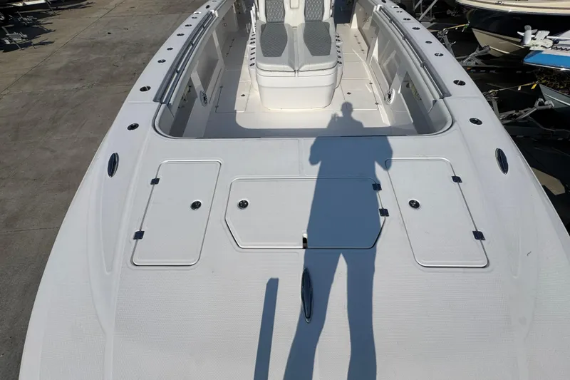 Slide: The Image of 2024 Invincible 46 Catamaran deck view with seating and storage compartments. - 12