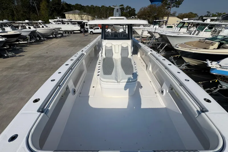 Slide: The Image of 2024 Invincible 46 Catamaran in a boatyard, showcasing spacious deck and seating. - 14