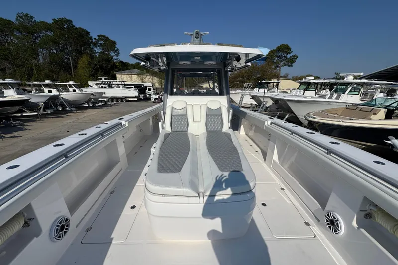 Slide: The Image of 2024 Invincible 46 Catamaran with spacious deck and luxurious seating in a marina. - 15