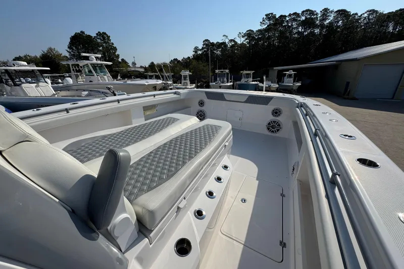 Slide: The Image of 2024 Invincible 46 Catamaran interior with cushioned seating and sleek design. - 18