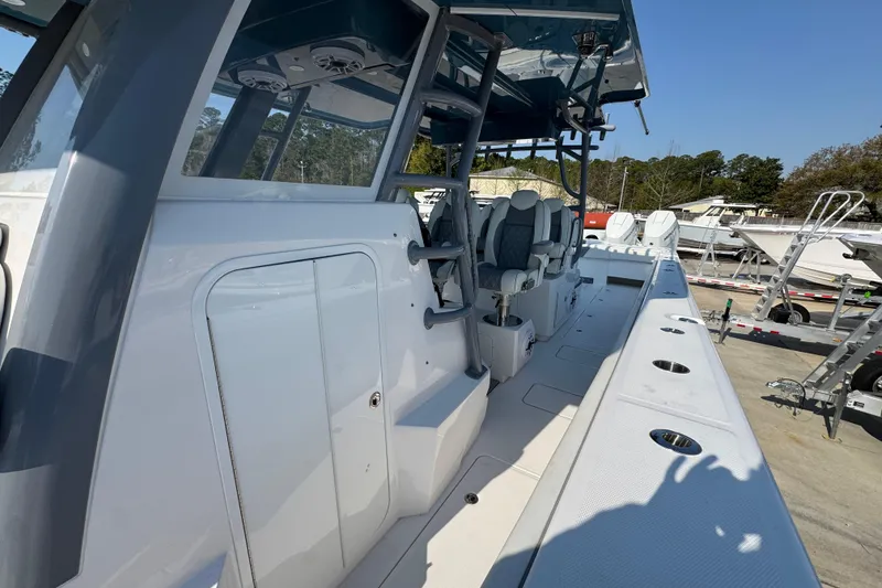 Slide: The Image of 2024 Invincible 46 Catamaran with sleek deck design and modern seating arrangement. - 19