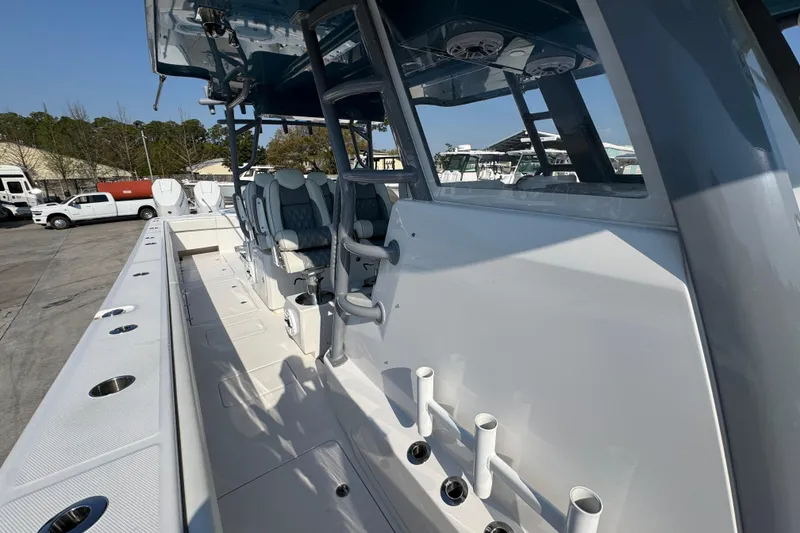 Slide: The Image of 2024 Invincible 46 Catamaran with sleek seating and fishing rod holders on deck. - 20