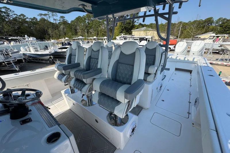 Slide: The Image of 2024 Invincible 46 Catamaran with luxurious seating and modern helm, docked at a marina. - 21
