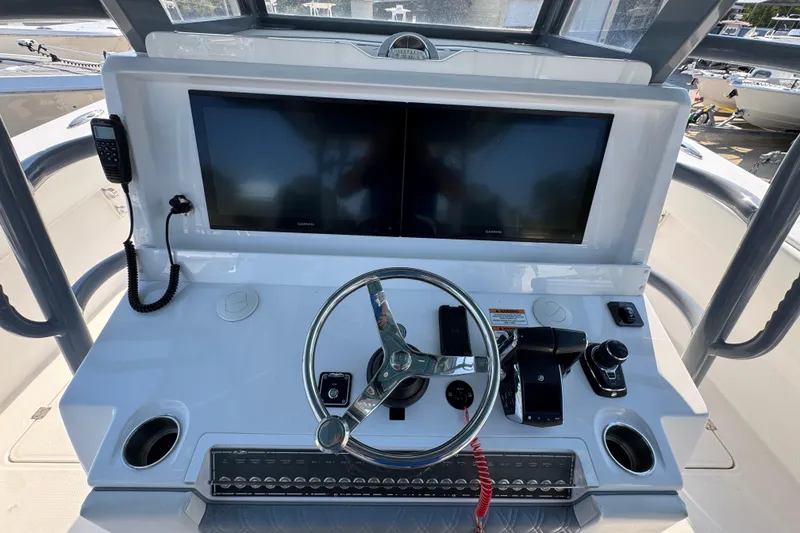 Slide: The Image of Helm of 2024 Invincible 46 Catamaran with dual screens and modern controls. - 27