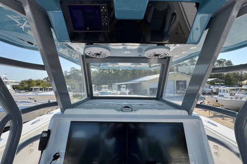 Slide: The Image of 2024 Invincible 46 Catamaran helm with dual screens and overhead speakers. - 28