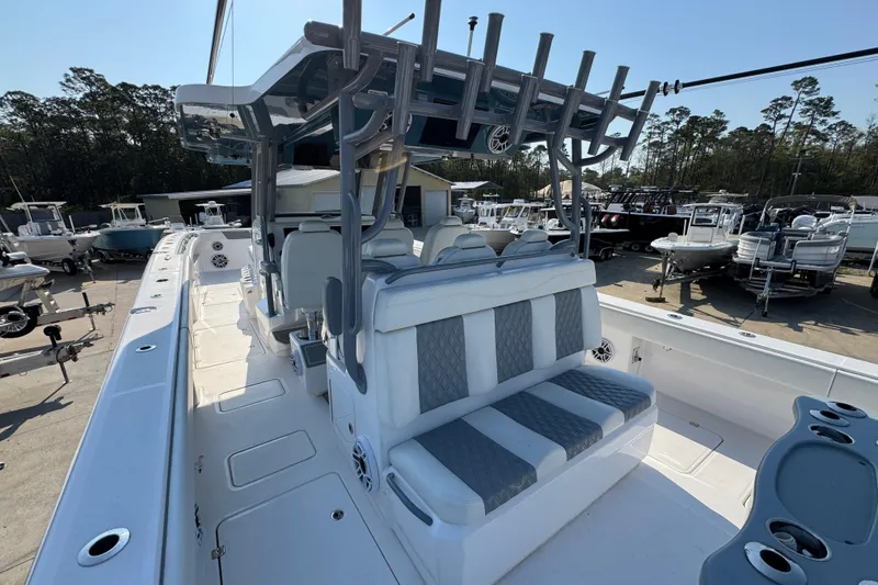 Slide: The Image of 2024 Invincible 46 Catamaran with spacious seating and modern design in a marina setting. - 31