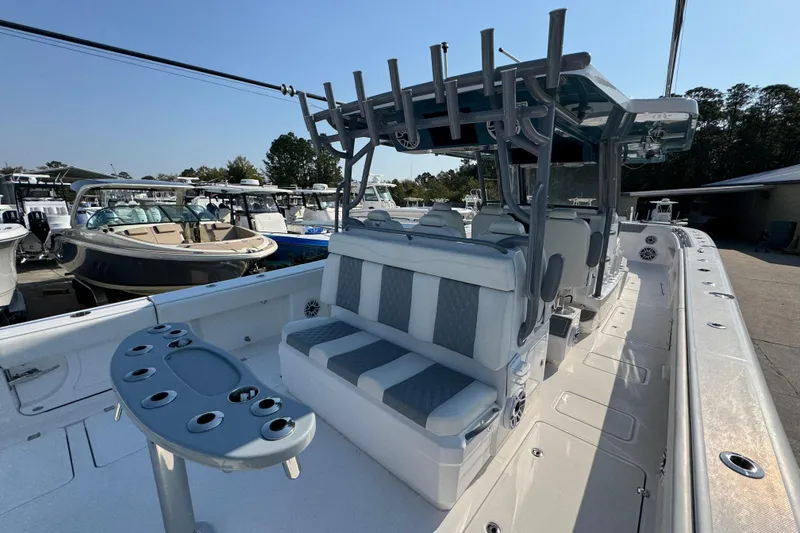 Slide: The Image of 2024 Invincible 46 Catamaran with spacious seating and modern design in a marina setting. - 33