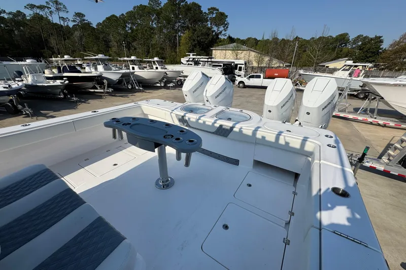Slide: The Image of 2024 Invincible 46 Catamaran with triple Mercury outboards in a boatyard setting. - 36